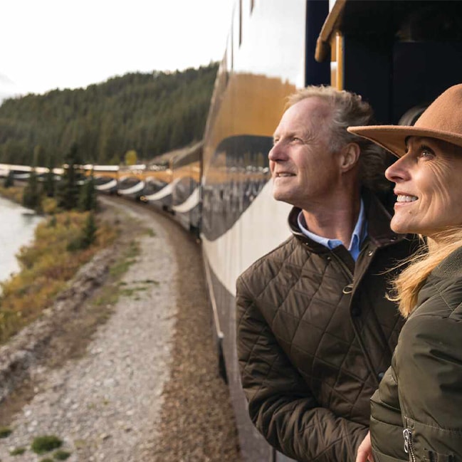 Couple looking out of window on the Rocky Mountaineer, Canada