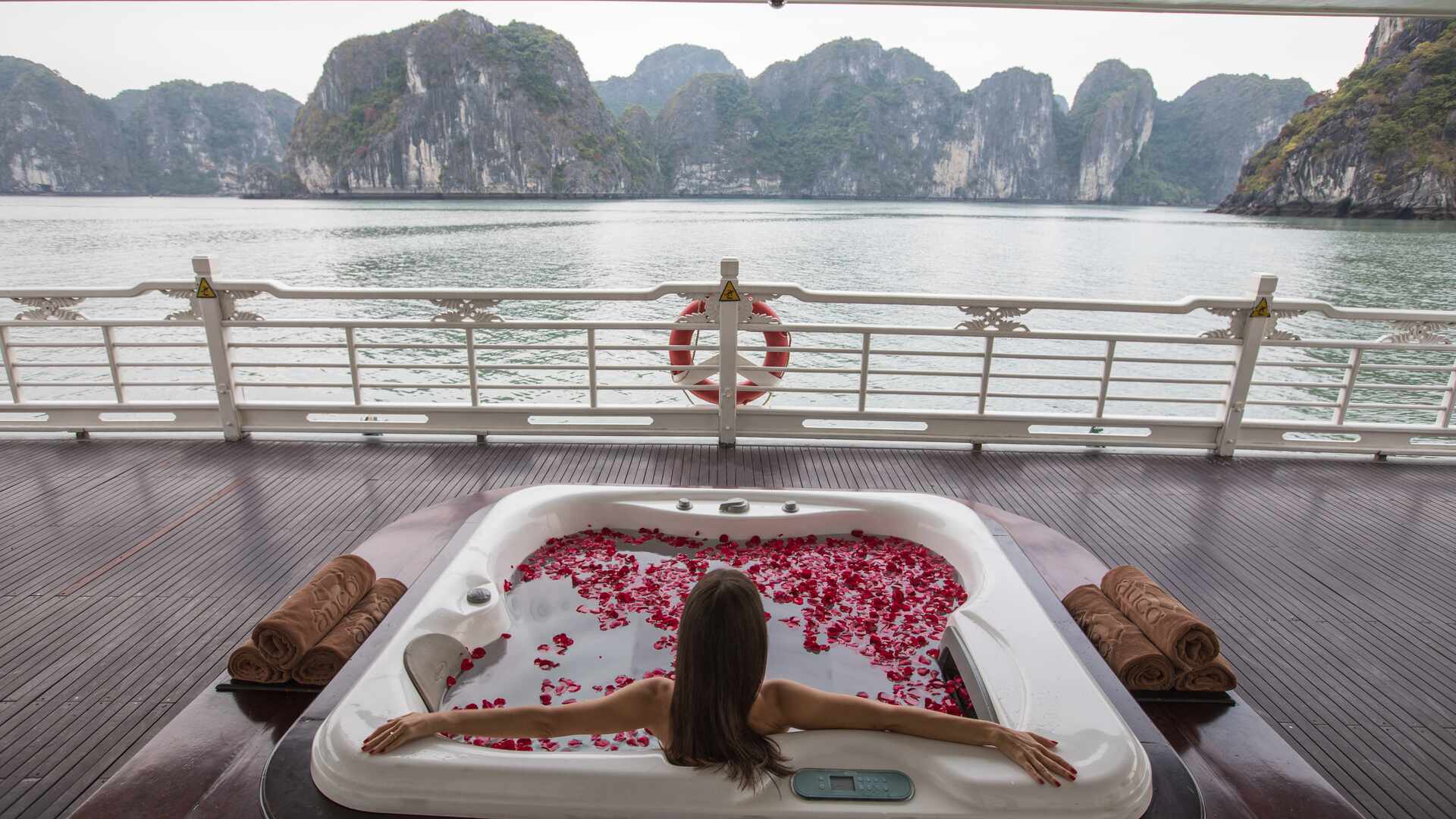 Woman relaxing in the Jacuzzi onboard the Au Co, Ha Long Bay