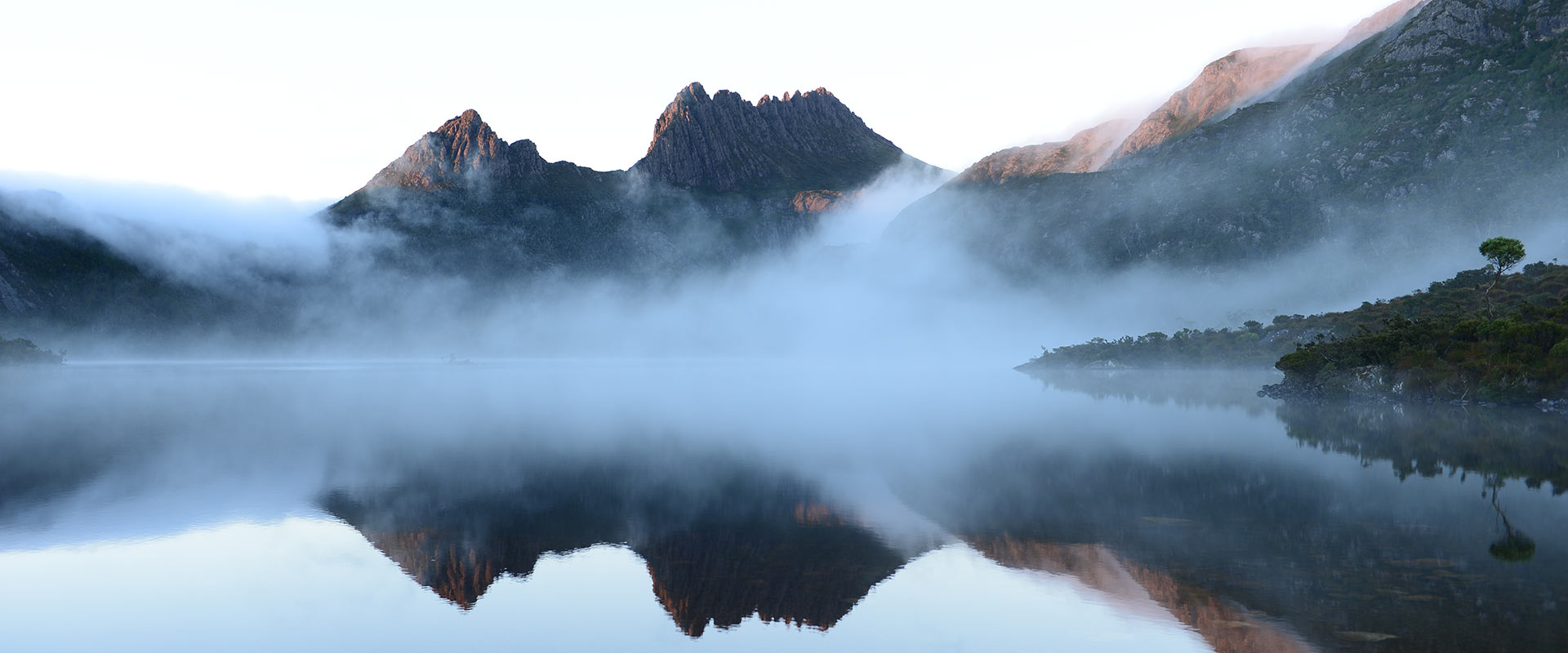 View of mountains and lake covered my misty fog, Tasmania
