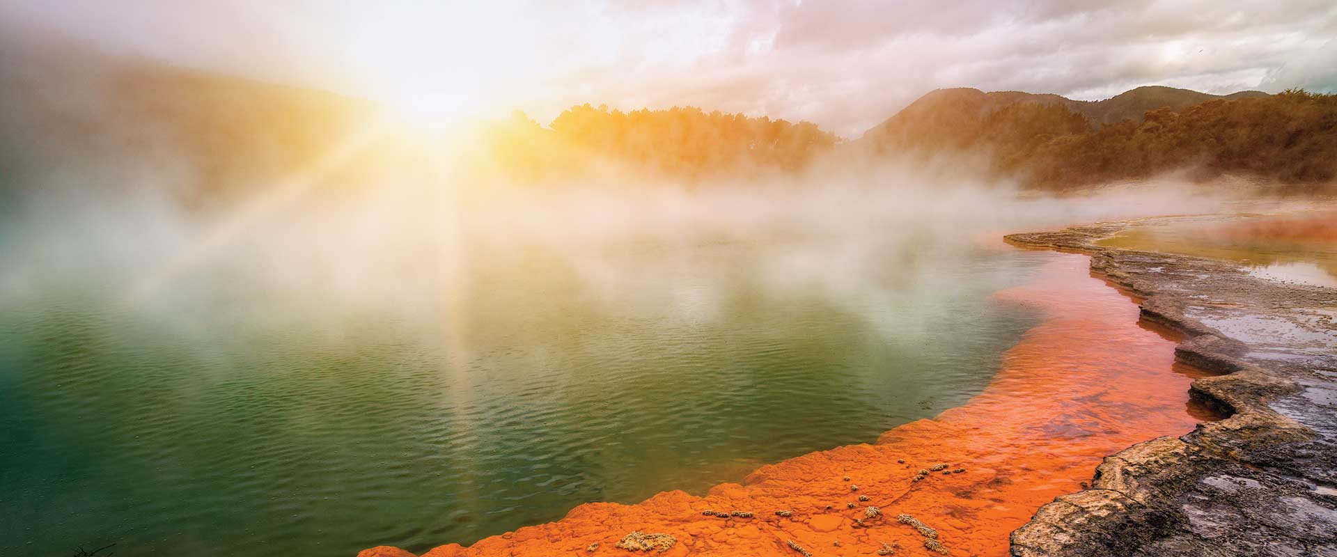 Steaming natural pool at sunset, New Zealand
