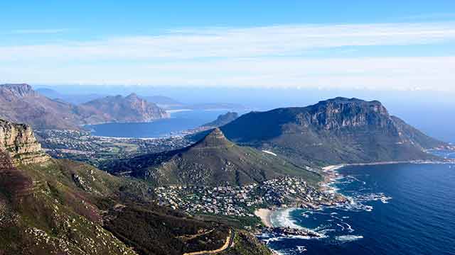 Large mountains with a township along the coast line, South Africa