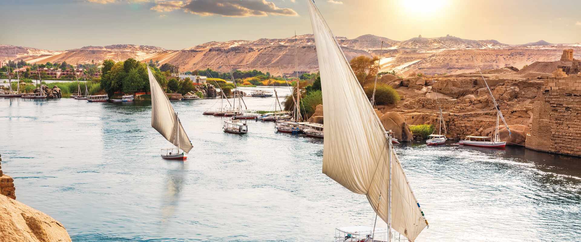 Boats sailing down the Nile at sunset