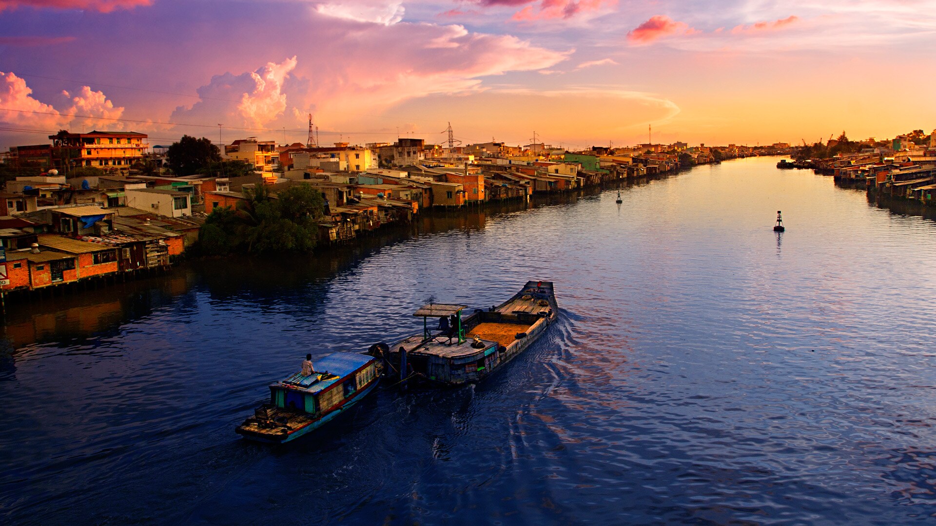 Two ships cruising along the Mekong River at sunrise, Vietnam