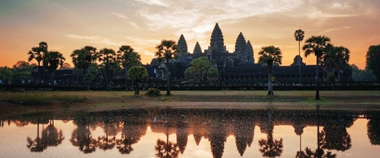Silhouette of Angokr Wat reflecting in the lagoon at sunrise, Cambodia
