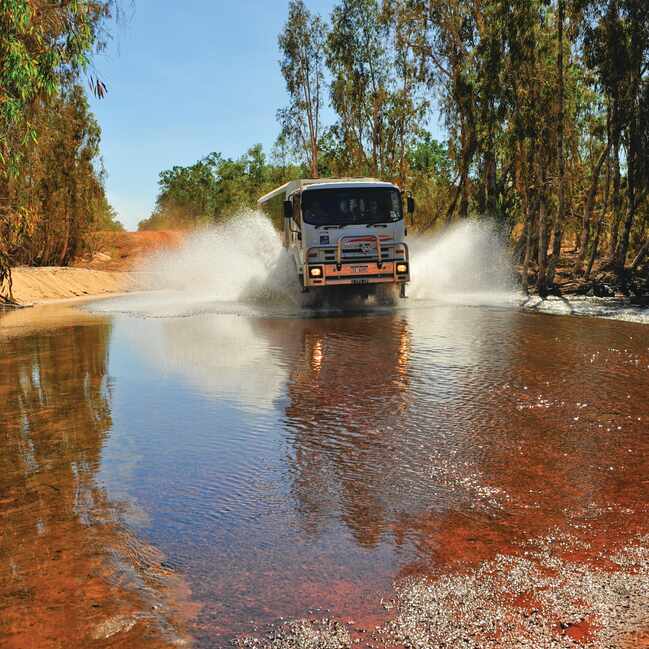 APT four wheel drive crossing some water in the outback.