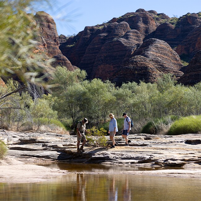 Couple following guide through picaninny creek, Kimberley