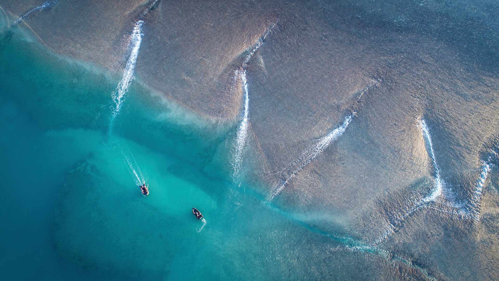 Two zodiac boats explore Montgomery Reef on the Kimberley coast