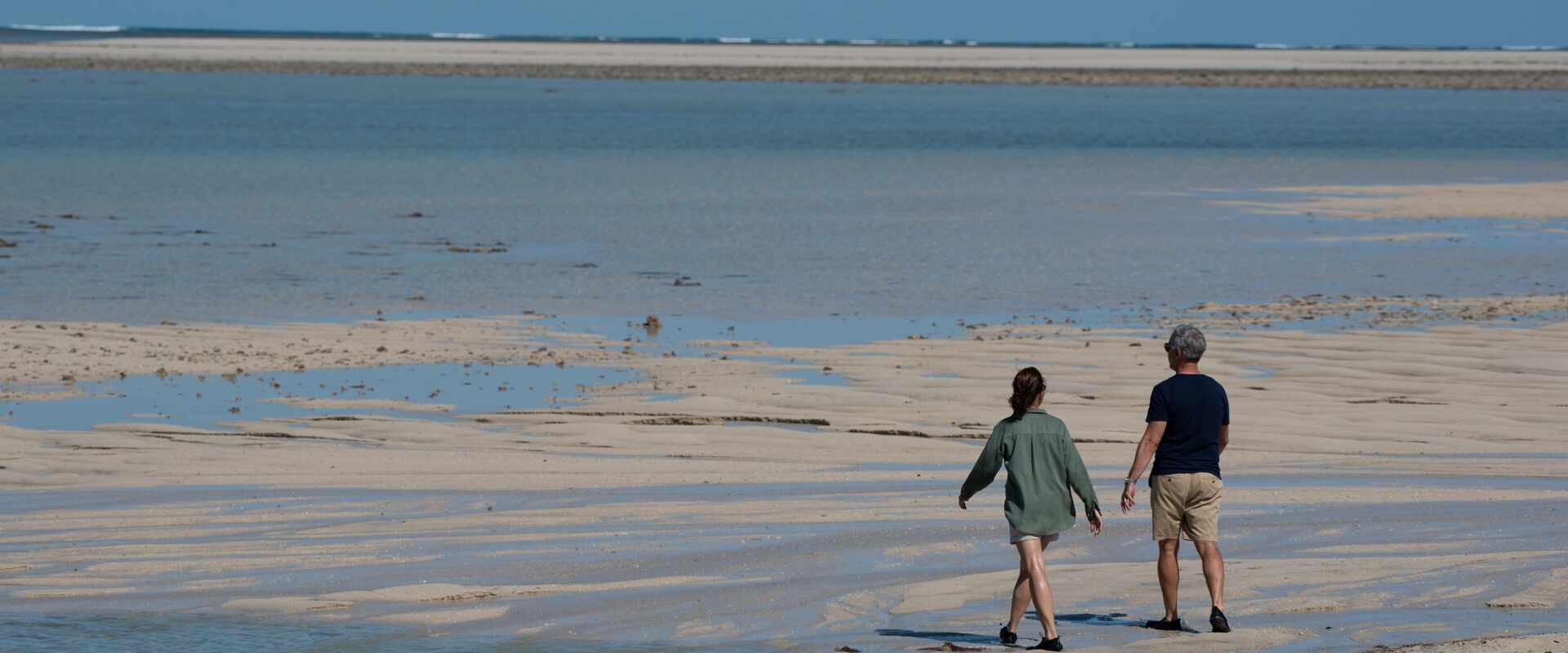 View of pax walking on shore of Adele Island, Kimberley
