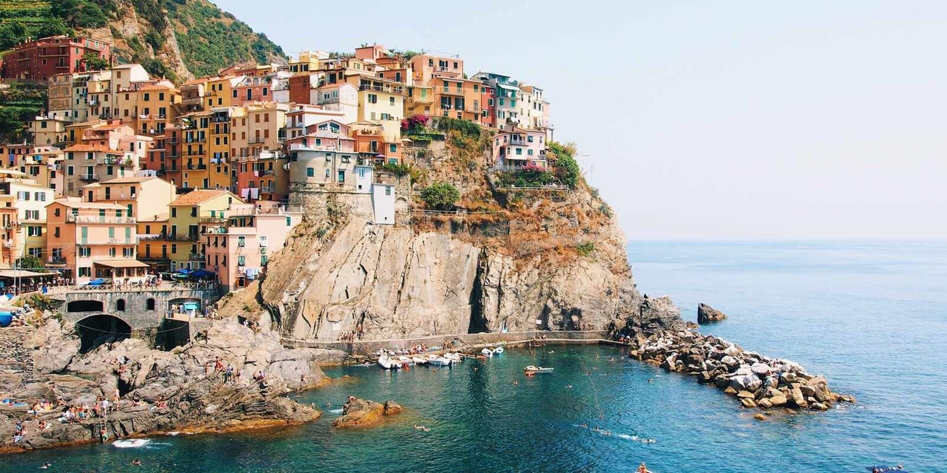 Colourful houses perched on a cliff in Cinque Terre, Italy