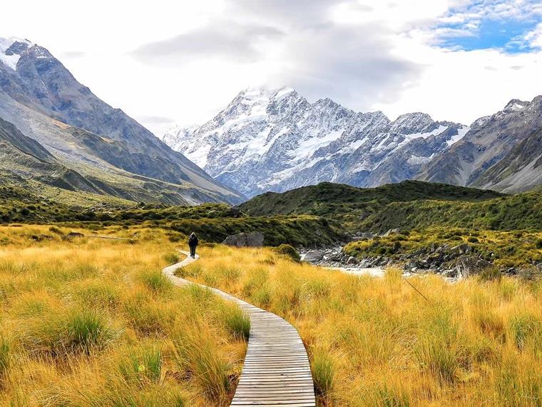 Person walking along a path in Mt Cook National Park, South island New Zealand