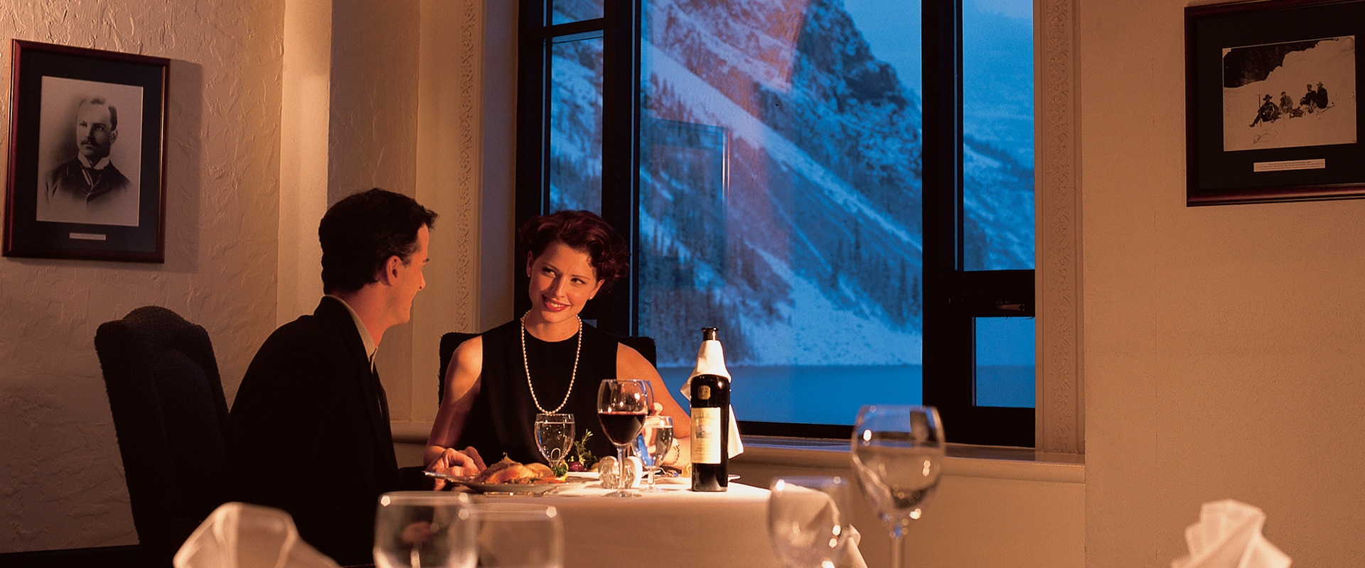Couple dining in a restaurant during winter at the Fairmont Chateau Lake Louise, Canada