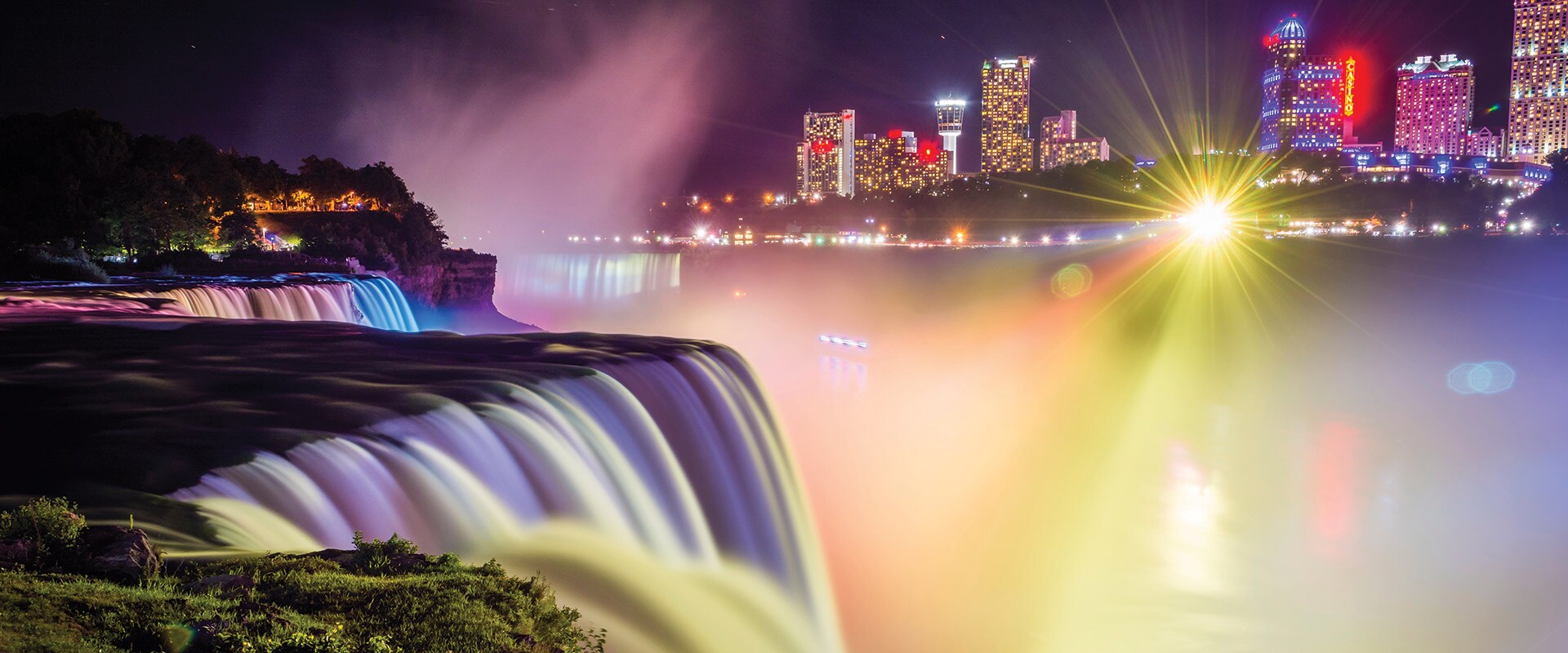 Night view of Niagara Falls with city lights, Canada