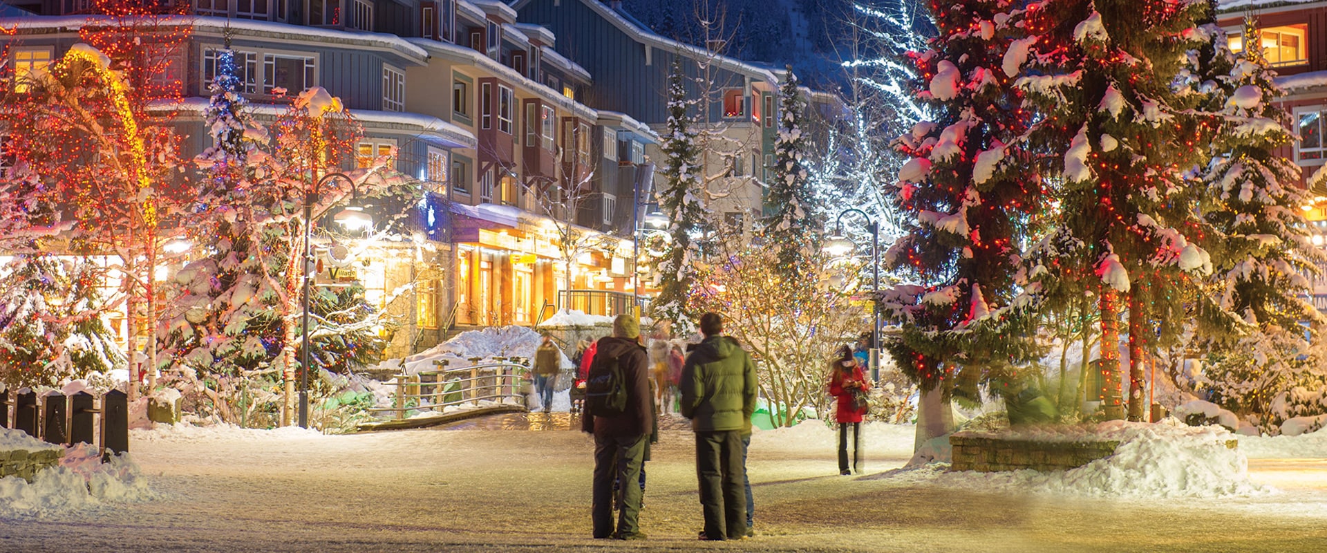 People standing in Whistler Village admiring the Christmas lights, Canada