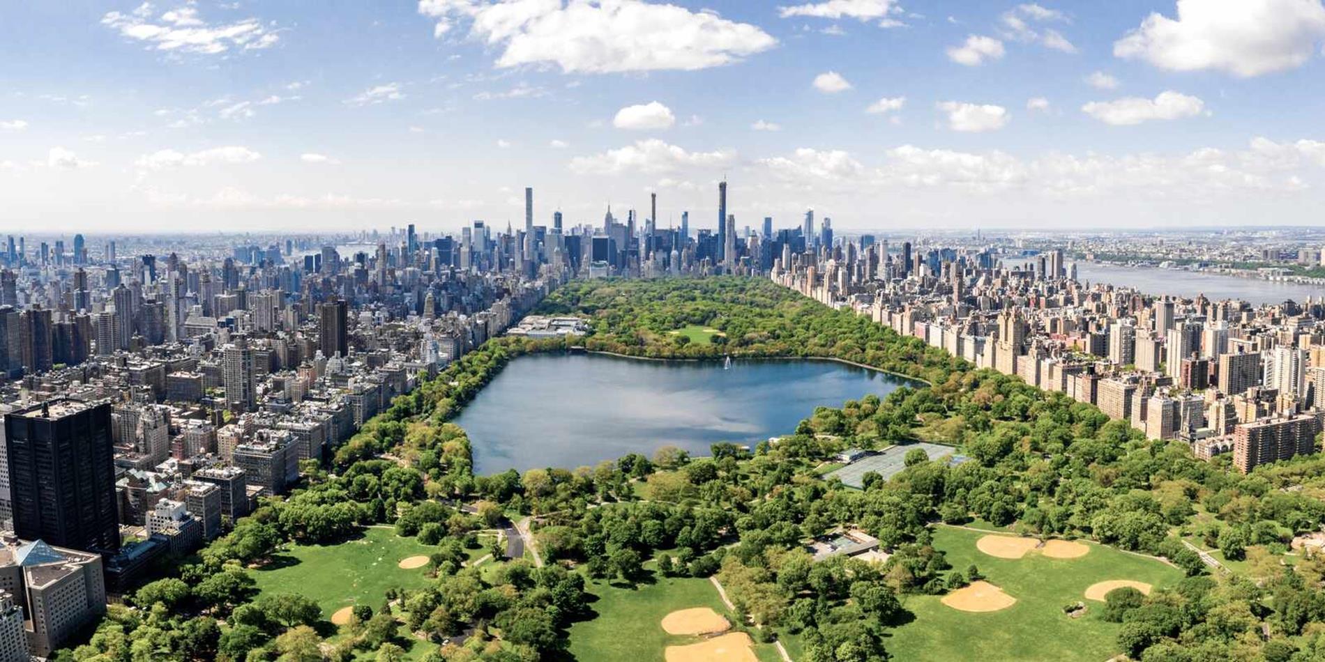 Aerial long distance view of New York Cty surrrounding Manhattan's Central Park