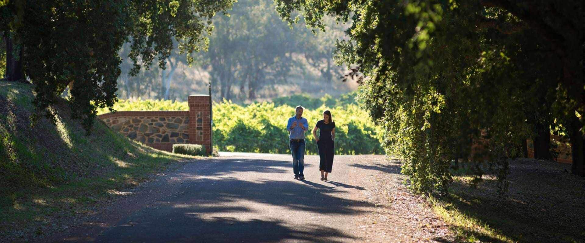 A couple walking along the driveway of St Hugo