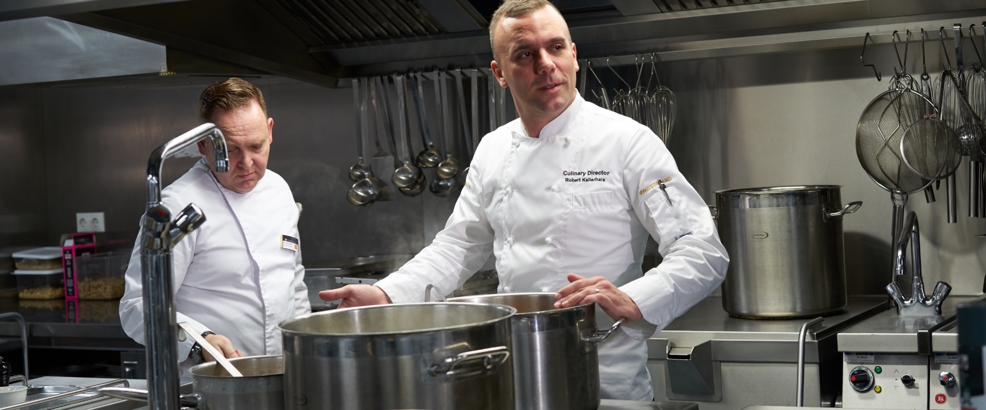 Robert kellerhals erc executive chef in galley behind large saucepan europe 12 5