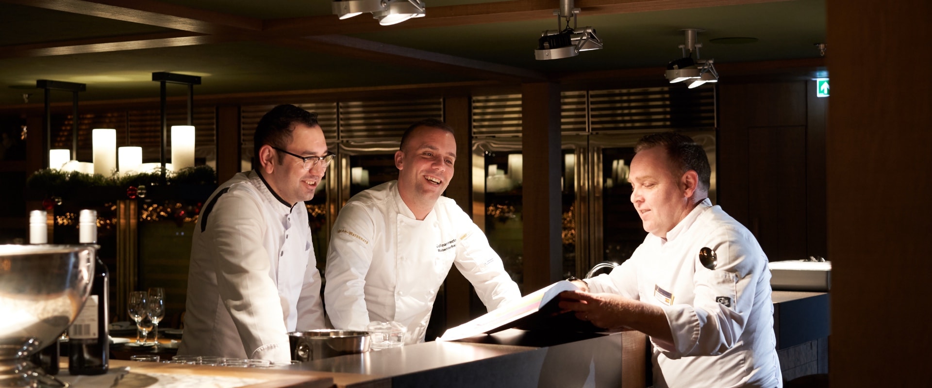 robert kellerhals erc executive chef laughing with staff in ship galley, europe 12 5