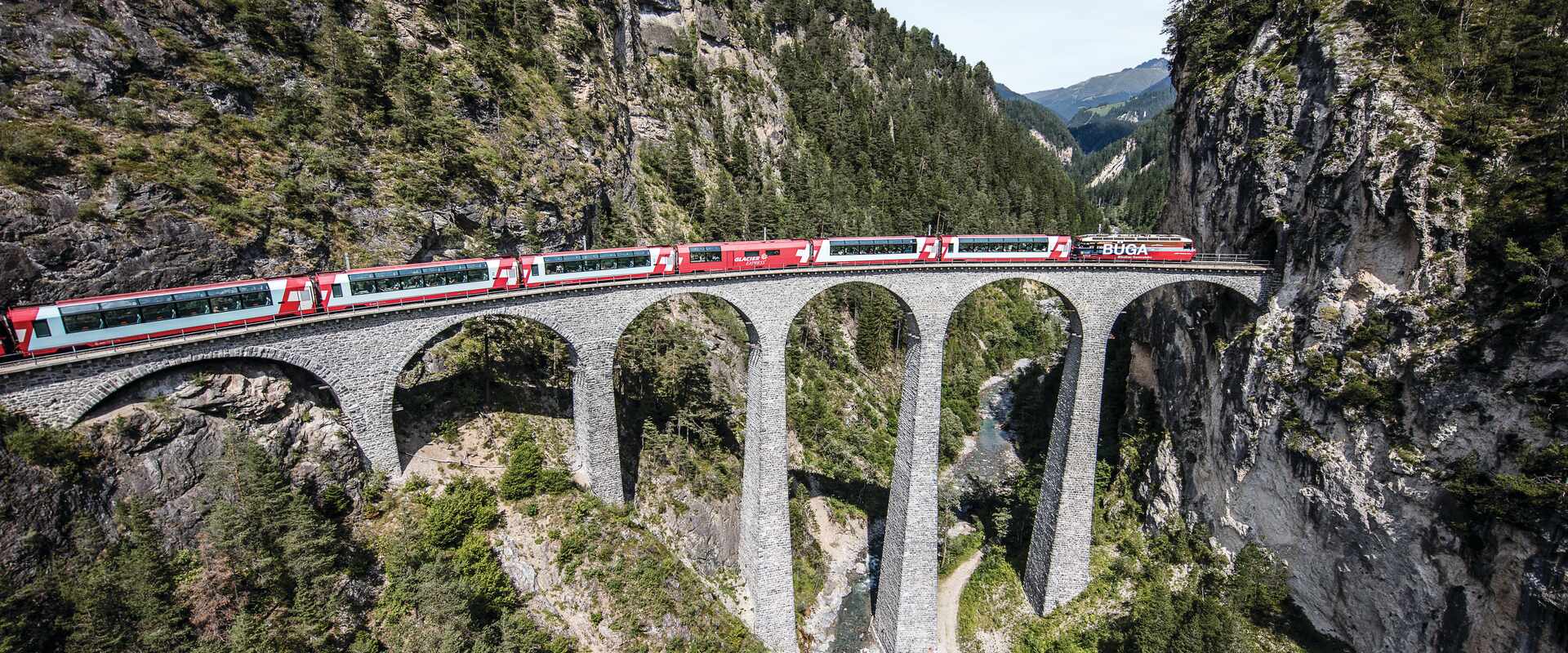 Glacier Express travelling over a viaduct in Switzerland