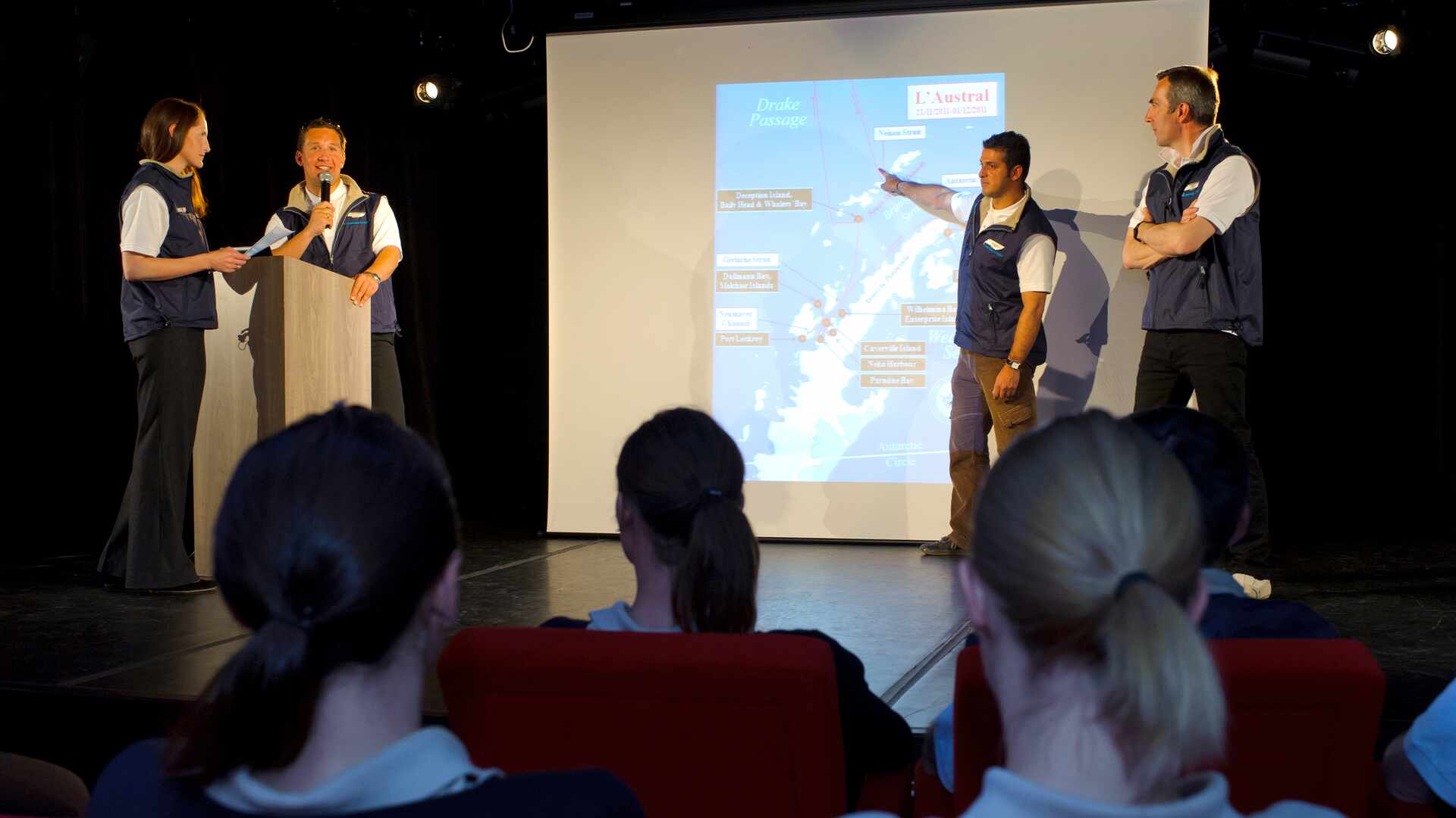 cruise operators and staff on a stage giving a presentation to an audience