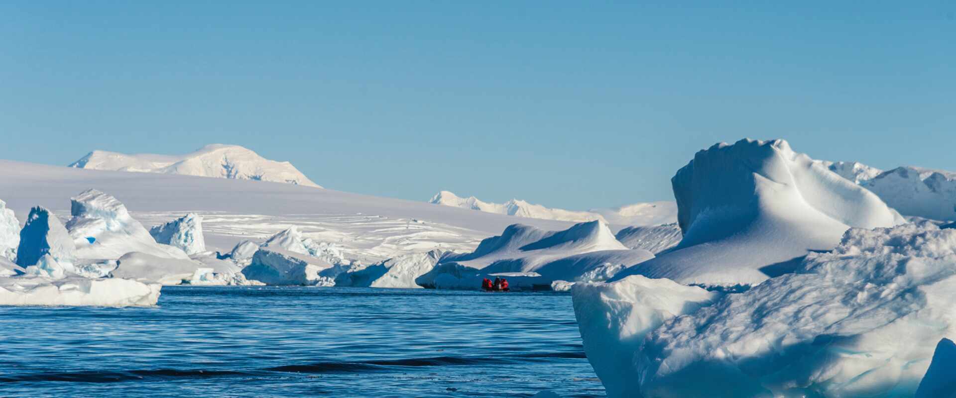 Passengers cruising around icebergs in Zodiac in Hanusse Bay, Antarctica
