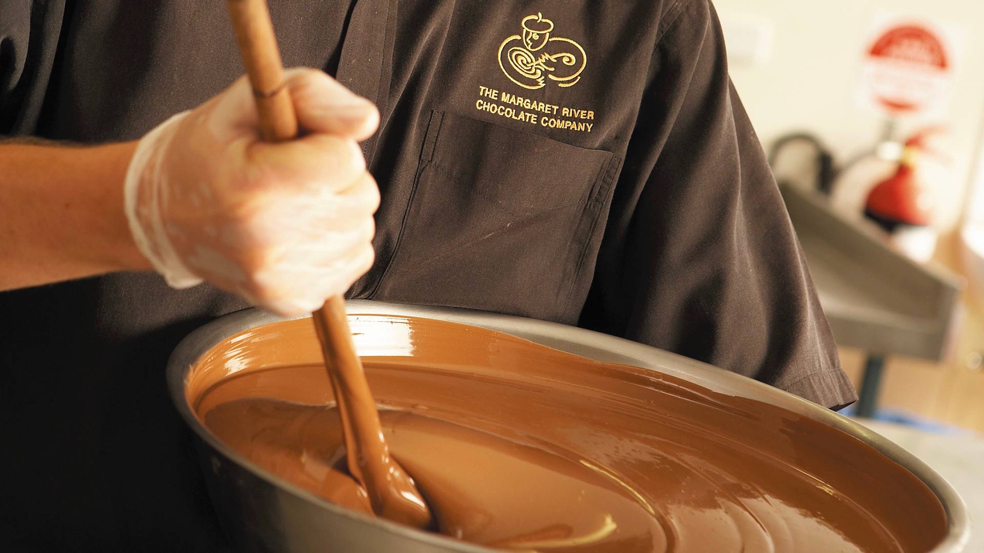 chocolatier stirring chocolate in bowl at margaret river chocolate company western australia