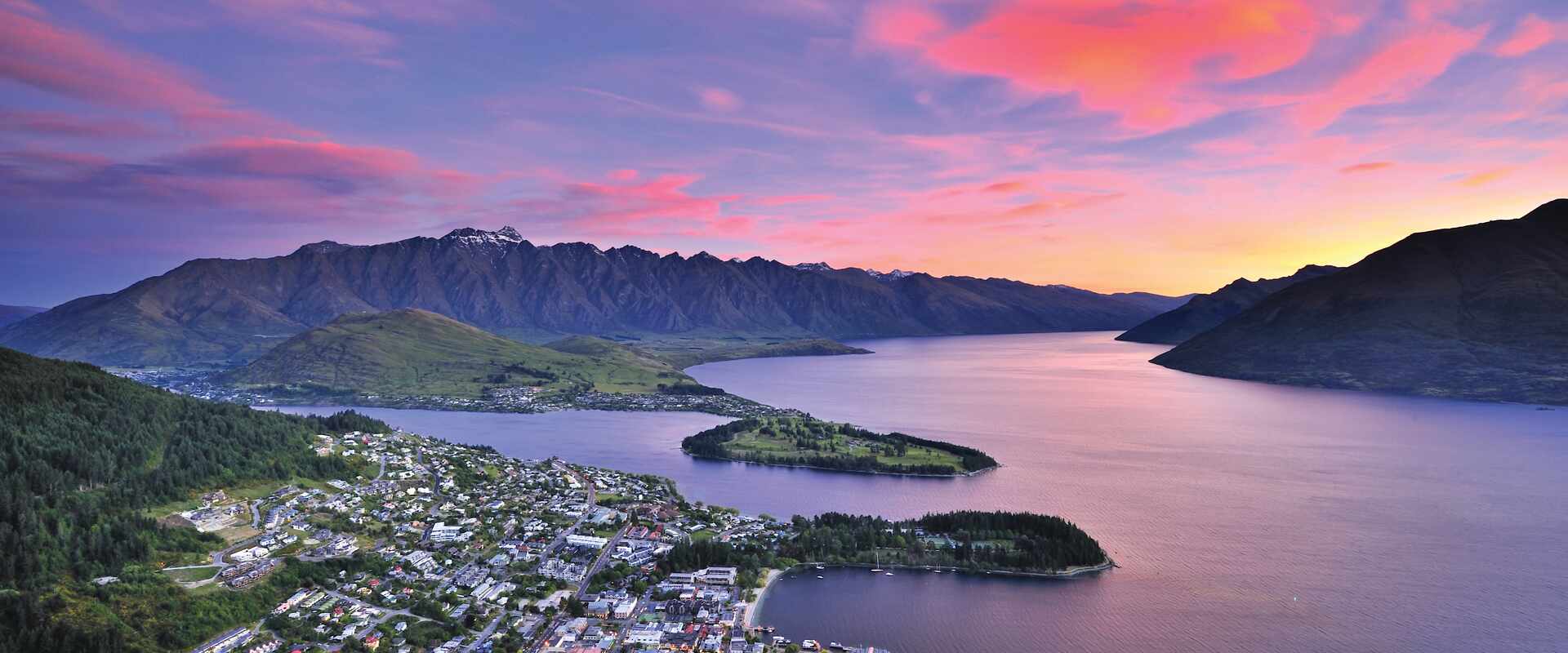 Aerial view over Lake Wakatipu and Queenstown lakesie town at sunset
