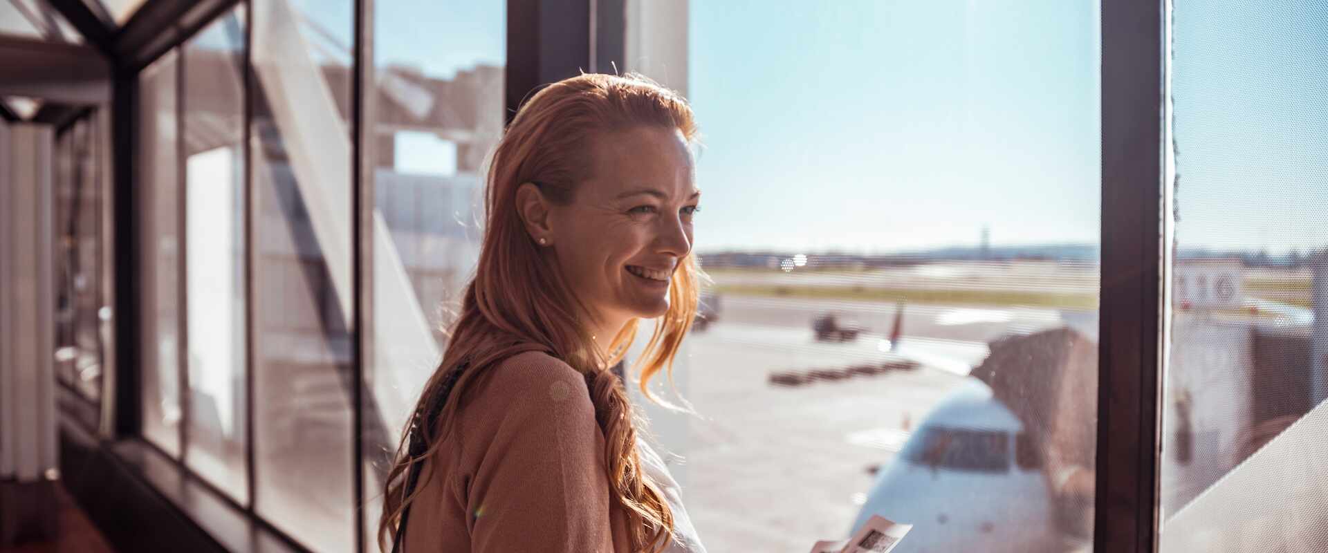 Close up of a young woman waiting to board the plane at the airport